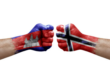 Two hands punch to each others on white background. Country flags painted fists, conflict crisis concept between cambodia and norway