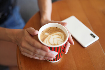 hands holding a cup of coffee