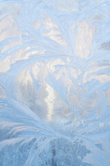 Ice patterns on glass, snow on the window, winter background