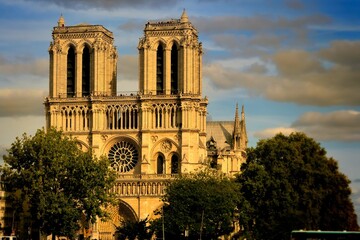 Cathedral of Notre-Dame in Paris feather clouds blue sky front view