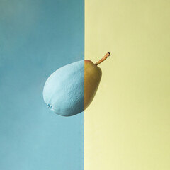 Two parts of pear on two pastel colored background. Modern fruit concept. Tasty food idea. Minimalistic health composition.