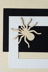 paper background with frame and wooden spider