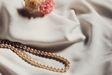 pink and white rose hair accessories and pearl necklace...
