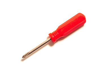 Fototapeta premium Small Phillips screwdriver with red plastic handle isolated on white background. Hand tool for tightening screws and self-tapping screws.