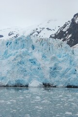 snow covered mountains near water and lake