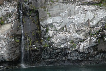 snow covered mountains near water and lake