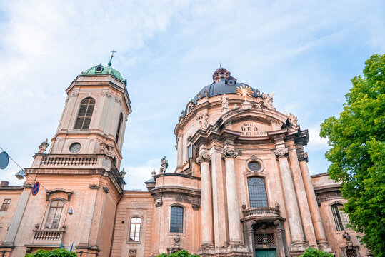 Low angle view of main facade with dome and spire of Dominican Church and Monastery against sky. Old historic building.