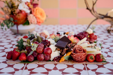 Charcuterie picnic board with meats cheeses and chocolate colorful 