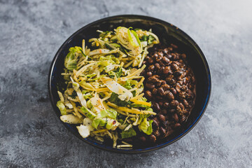 vegan nourish bowl with black beans and mixed greens, healthy plant-based food