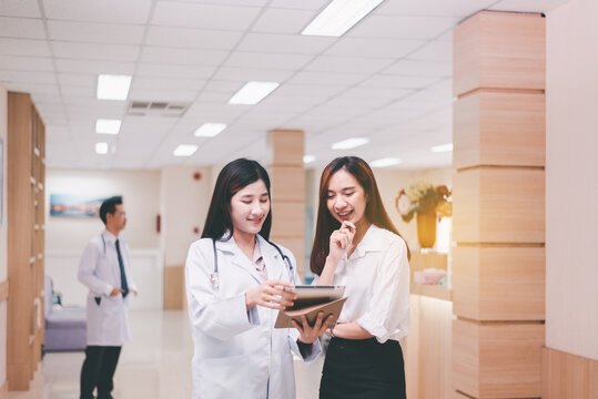 Doctor Talking With Woman Patient And Follow Up Treatment At Hospital