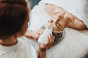 Beautiful woman receiving ultrasound cavitation facial peeling. Beauty skin. Beauty treatment....