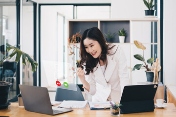 Asian business woman having video call with business team to consult about business plan of company. Online team meeting video conference.