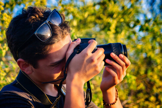 Young photographer taking pictures on a sunny day