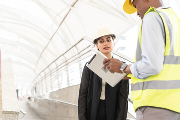 Fototapeta premium Group of Engineer Worker Wearing Safety Uniform and Hard Hat Uses Tablet Computer. Happy Successful. Businesswomen working with tablet checklist