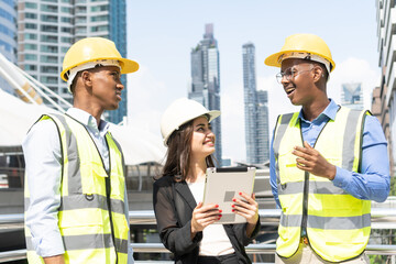 Group of Engineer Worker Wearing Safety Uniform and Hard Hat Uses Tablet Computer. Happy Successful. Businesswomen working with tablet checklist
