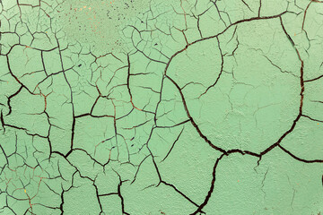 Cracked and damaged painted surface of a building or wall. Texture, aged paint background