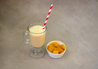 Yellow Indian mango yoghurt drink Mango Lassi or smoothie with turmeric and saffron.