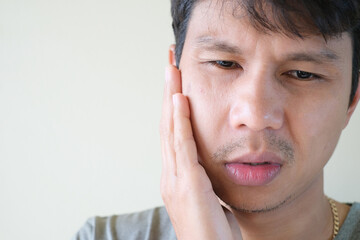 Teetch problem. Asian male with painful cheek swelling or dental abscess. A facial injury, tooth...