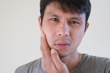 Teetch problem. Asian male with painful cheek swelling or dental abscess. A facial injury, tooth...