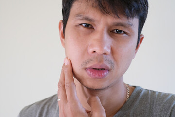 Teetch problem. Asian male with painful cheek swelling or dental abscess. A facial injury, tooth...