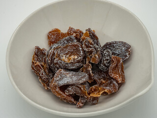 A bowl of pickled sweet and sour dried plum