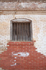 Fototapeta na wymiar Close-up Building Detail - Vintage Jail Window and Brick Wall