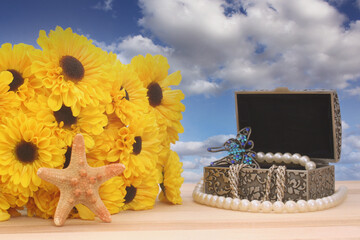 Flowers and Angel with Butterflies and Jewelry Box on Blue Sky Background