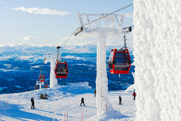 Ski resort in sunny day. Red cable car in a ski resort in the Alps. red gondola funicular in a ski resort in sweden on a frosty sunny day