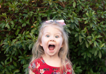 Excited little girl's facial expression. Emotional child