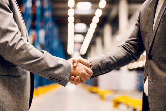 Close up of a handshake of business partners at storage.