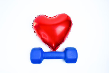 Blue dumbbell and red balloon heart, a background for lifestyle healthy.