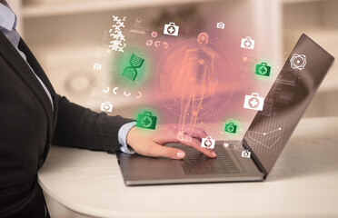 Doctor working on laptop with healthcare concept