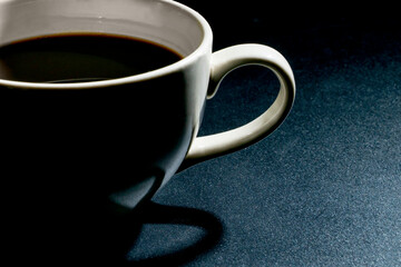 close-up white coffee cup on a black background