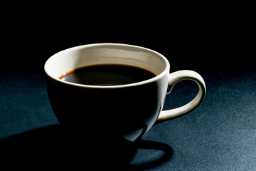 close-up white coffee cup on a black background