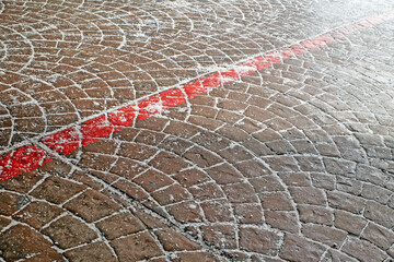 Snow-covered paving stones at the exit of the underpass