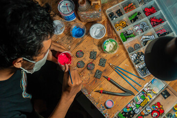 Craft pins made of acrylic and colored using enamel paint, all done manually in a home workshop