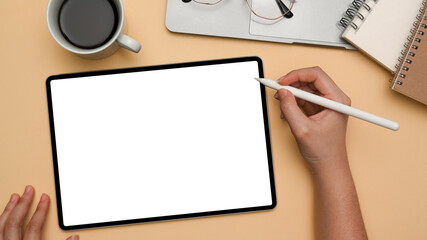 A female designer sketching or drawing graphic image on digital tablet