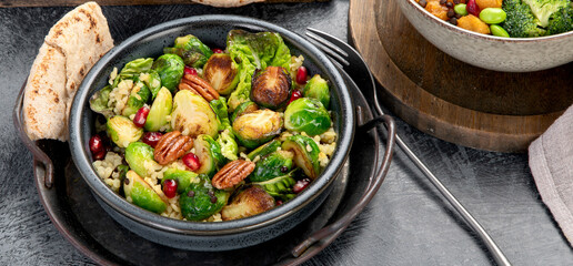 Brussel sprout salad with bulgur on dark background.