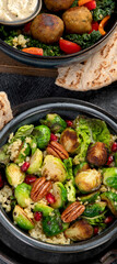 Brussel sprout salad with bulgur on dark background.