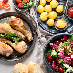 Baked chicken legs with salad and potatoes