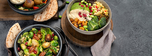 Brussel sprout salad with bulgur on dark background.