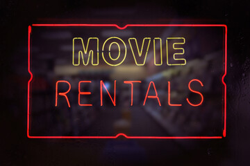 Neon Movie Rentals Sign in Wet Rainy Window