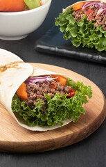 Delicious wrap sandwich of lettuce, onion, carrot and minced beef..