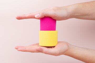 Woman hands holding medical colorful tapes rolls. Physical therapy, rehabilitation concept