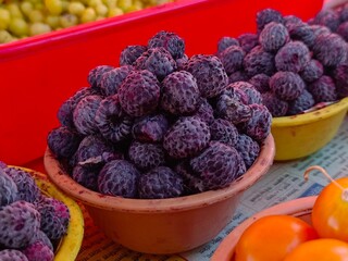 Local people selling ranmeva at the Mahabaleshwar like tomato, Forest food the real taste of nature, blueberry, guava, Red strawberries, berries, beetroots, indian gooseberry, tamarind.