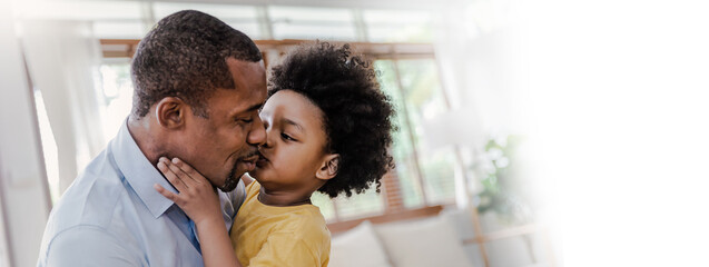 Portrait of american african black father and son hug laugh kiss in living room. Happy daddy and...