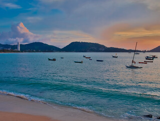 Fototapeta premium Long tail Boat on colourful sunset over Patong Beach Phuket Thailand