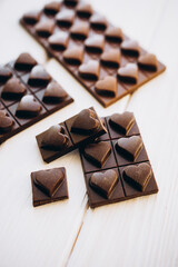 craft homemade milk and dark chocolate on a white wooden background