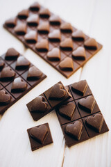 craft homemade milk and dark chocolate on a white wooden background
