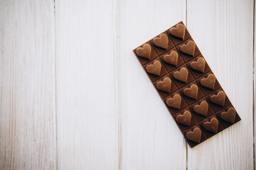craft homemade milk chocolate on a white wooden background
